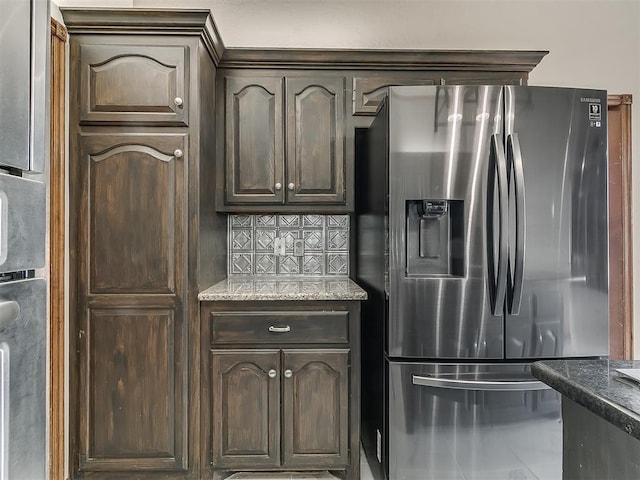 kitchen featuring stainless steel refrigerator with ice dispenser, stone counters, dark brown cabinets, and backsplash