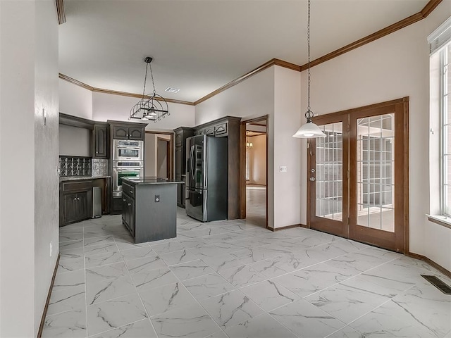 kitchen with decorative light fixtures, a center island, appliances with stainless steel finishes, french doors, and dark brown cabinets