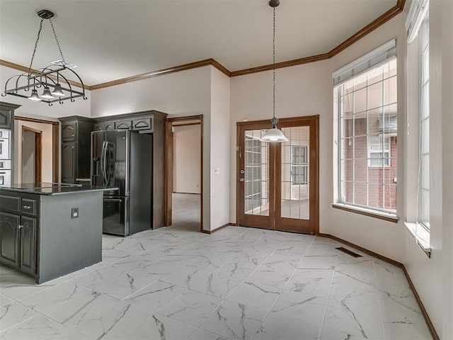 kitchen featuring stainless steel fridge with ice dispenser, black electric cooktop, hanging light fixtures, oven, and ornamental molding