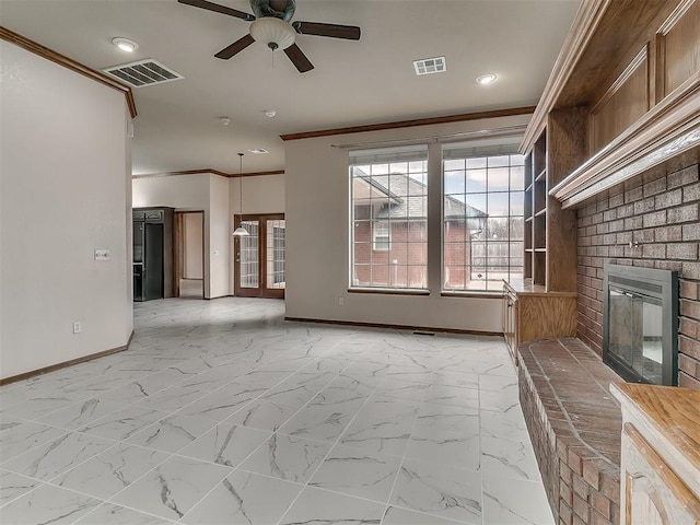 unfurnished living room featuring ceiling fan, ornamental molding, and a fireplace