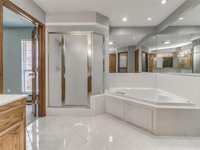 bathroom featuring shower with separate bathtub, tile patterned floors, and vanity