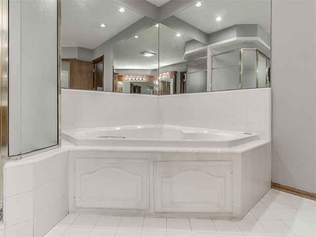 bathroom featuring tiled bath and tile patterned flooring