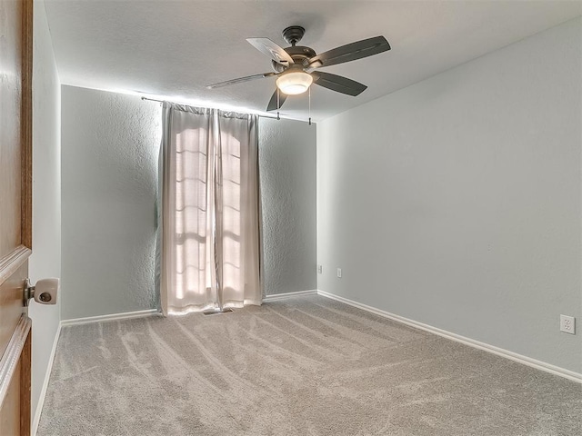 carpeted empty room with ceiling fan