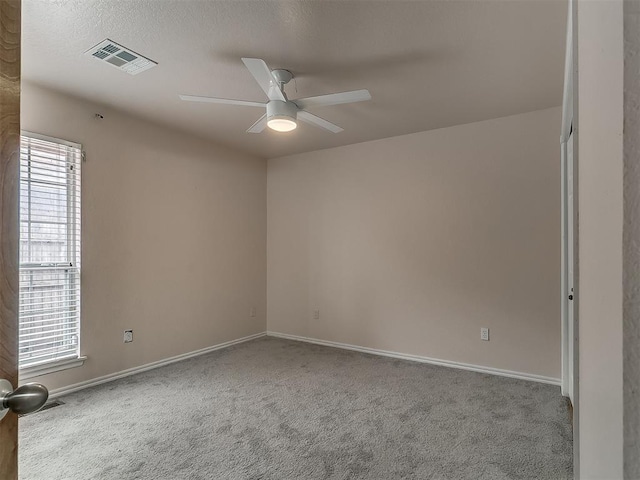 carpeted empty room featuring ceiling fan