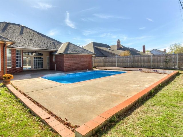 view of swimming pool with ceiling fan and a patio area