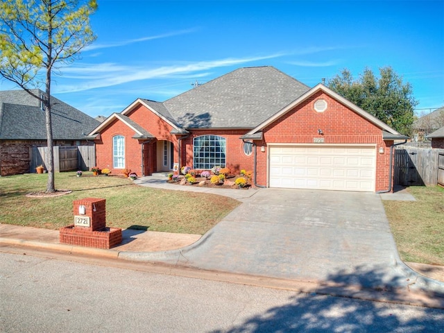 view of front facade featuring a front yard and a garage