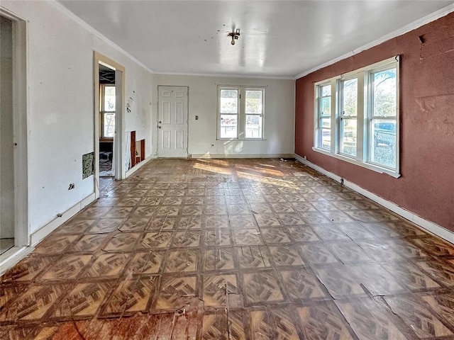 empty room featuring ornamental molding and parquet flooring