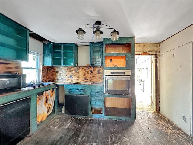 kitchen featuring hardwood / wood-style flooring, stainless steel oven, and green cabinets