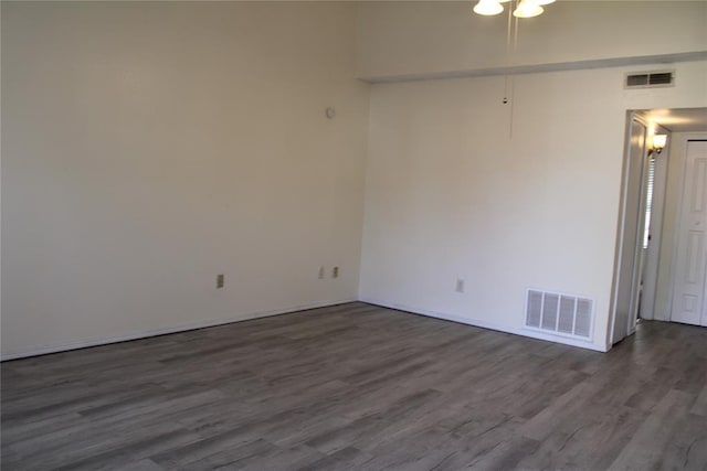 unfurnished room with dark hardwood / wood-style floors