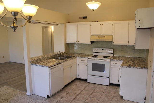 kitchen featuring sink, dark stone counters, white appliances, decorative backsplash, and white cabinets