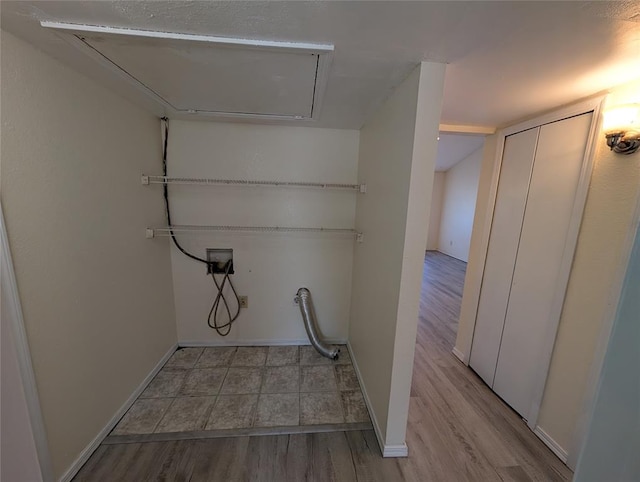 laundry room with hookup for a washing machine and light hardwood / wood-style flooring