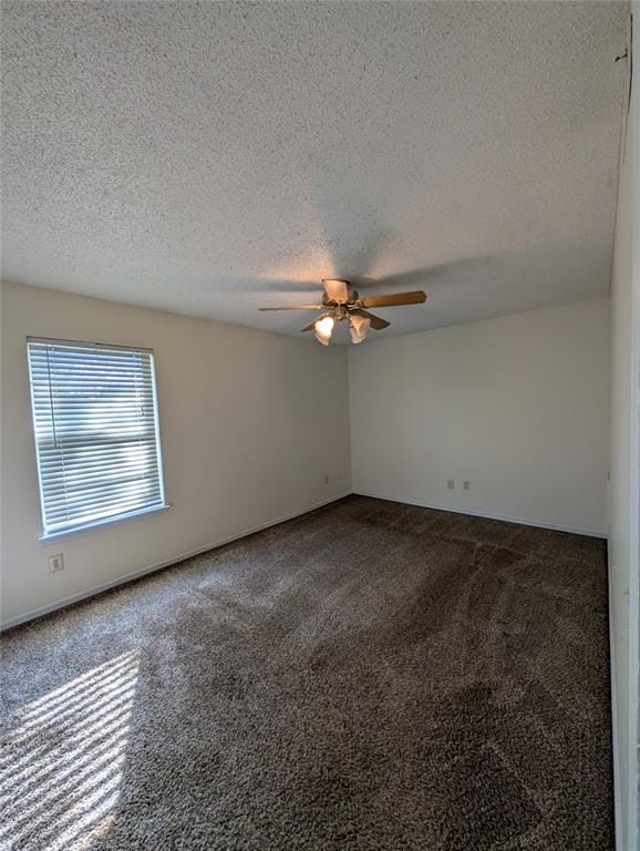 carpeted empty room with ceiling fan and a textured ceiling