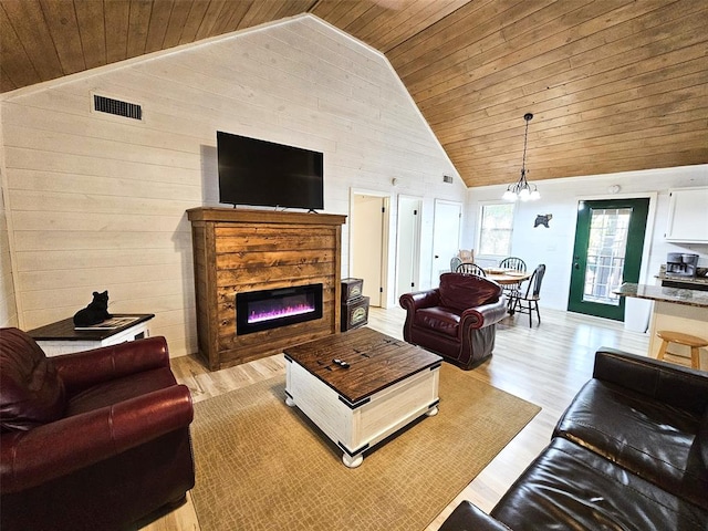 living room with a notable chandelier, wood ceiling, high vaulted ceiling, and light hardwood / wood-style flooring