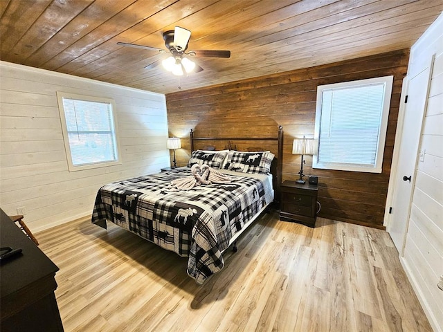 bedroom with wooden walls, light hardwood / wood-style flooring, ceiling fan, and wooden ceiling