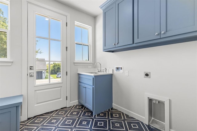 laundry room with cabinet space, hookup for a washing machine, hookup for an electric dryer, a healthy amount of sunlight, and a sink