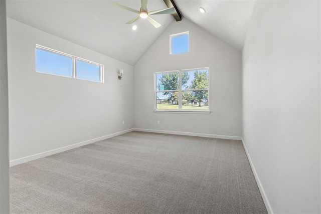 empty room featuring baseboards, ceiling fan, carpet floors, high vaulted ceiling, and beam ceiling