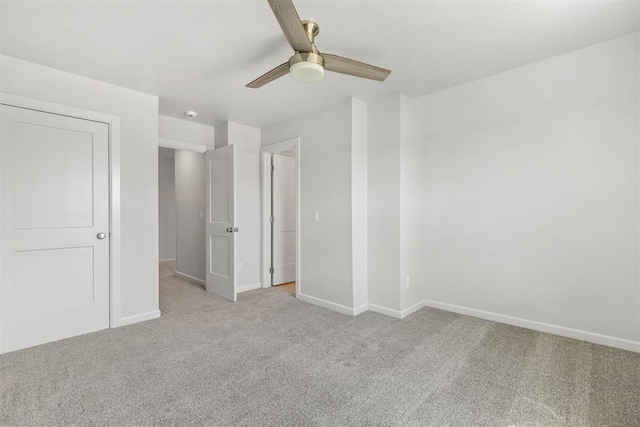 unfurnished bedroom with light carpet, baseboards, and a ceiling fan