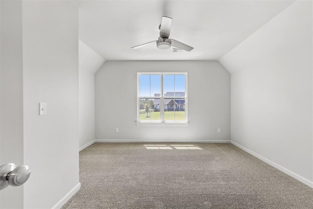 additional living space with ceiling fan, carpet flooring, visible vents, baseboards, and vaulted ceiling