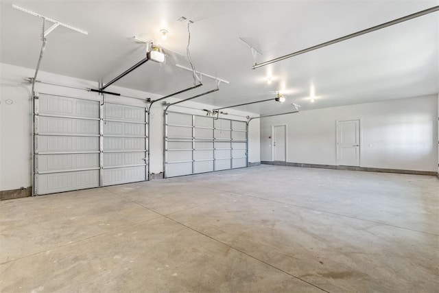 garage with baseboards and a garage door opener