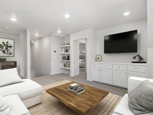 living area featuring recessed lighting, light carpet, and baseboards