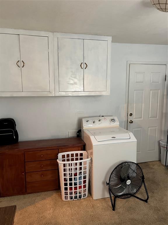 washroom with cabinets, washer / clothes dryer, and light colored carpet