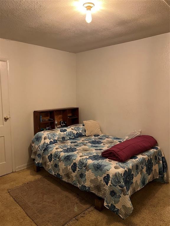 carpeted bedroom with a textured ceiling