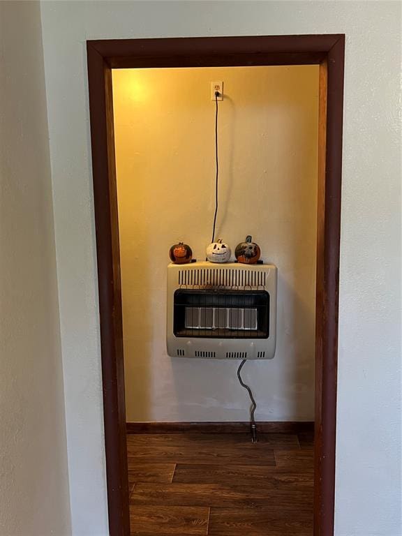 details with heating unit and hardwood / wood-style flooring