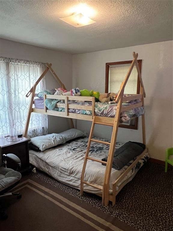 bedroom featuring carpet flooring and a textured ceiling