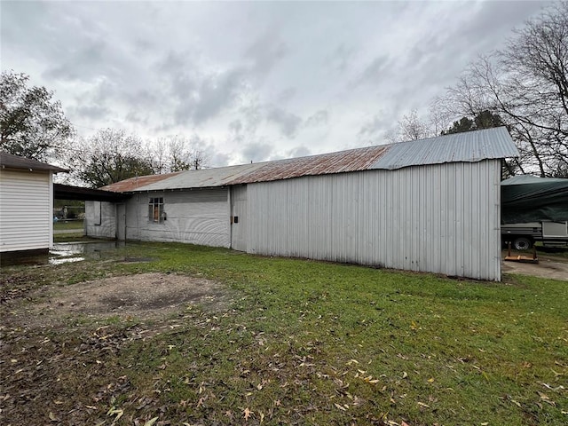 view of outbuilding featuring a yard