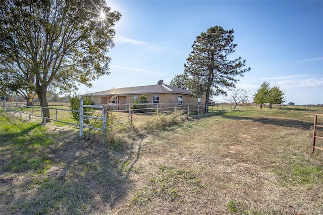 view of yard featuring an outbuilding and a rural view