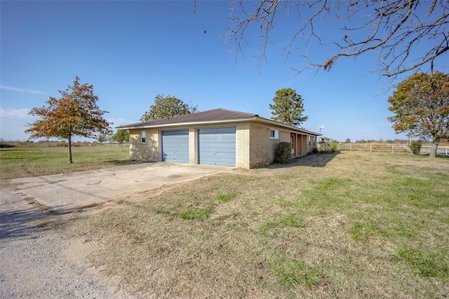 garage featuring a lawn