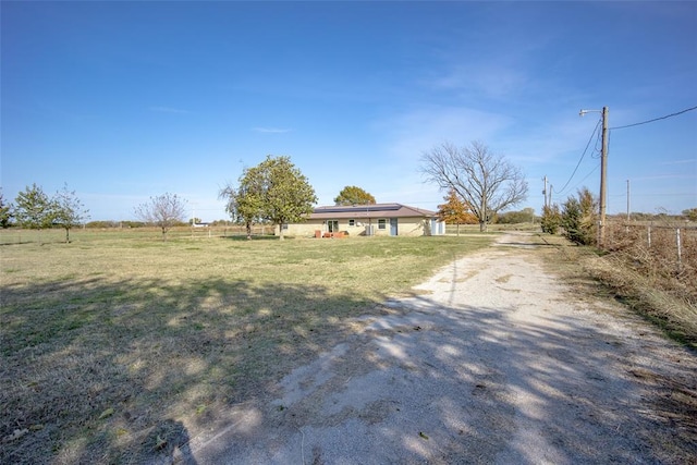 exterior space featuring a rural view and a front lawn