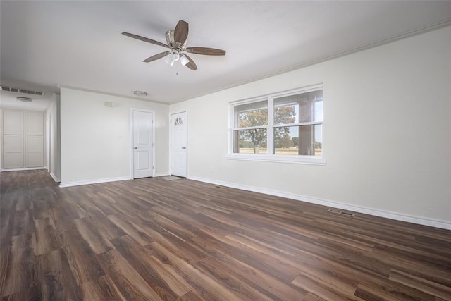 unfurnished room featuring ceiling fan, dark hardwood / wood-style flooring, and ornamental molding