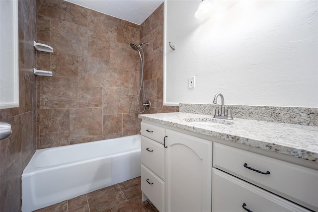 bathroom with vanity and tiled shower / bath