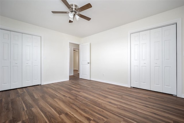 unfurnished bedroom with ceiling fan and dark wood-type flooring