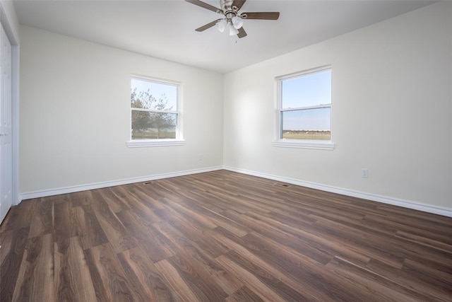 unfurnished room with dark hardwood / wood-style floors and ceiling fan