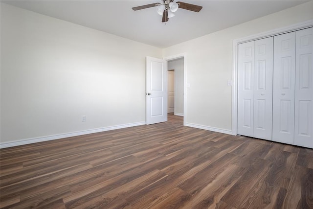 unfurnished bedroom featuring ceiling fan, a closet, and dark hardwood / wood-style floors