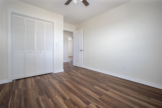 unfurnished bedroom with a closet, ceiling fan, and dark wood-type flooring