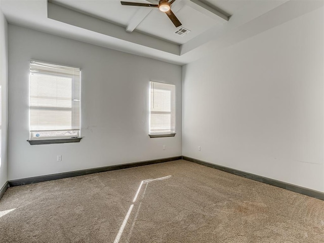 unfurnished room featuring a tray ceiling, ceiling fan, and carpet floors