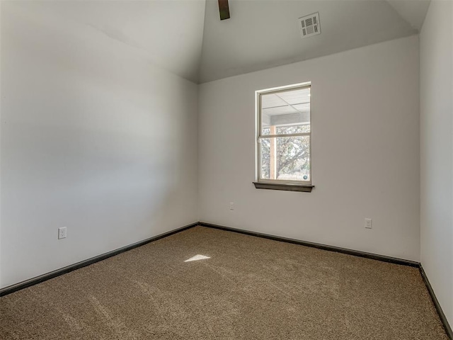 spare room with carpet and lofted ceiling