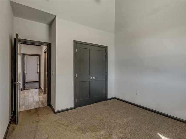 unfurnished bedroom with light carpet