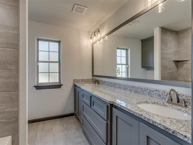 bathroom featuring tile patterned floors, plenty of natural light, and vanity