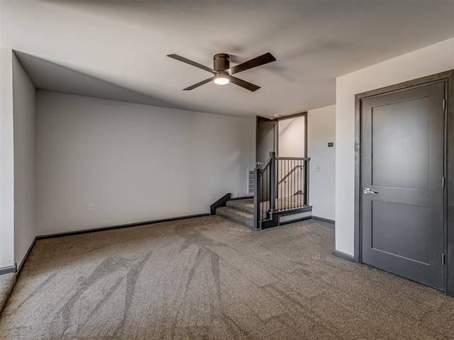 empty room with ceiling fan and carpet floors