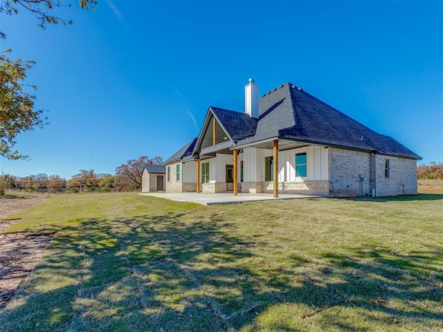 rear view of house featuring a lawn