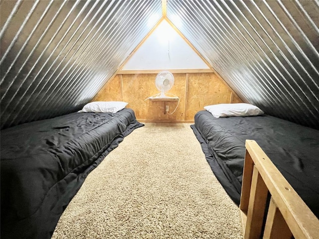 carpeted bedroom featuring wood walls and lofted ceiling