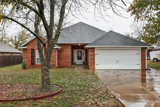 single story home featuring a garage and a front lawn