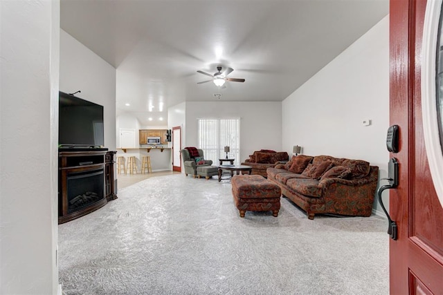 carpeted living room featuring ceiling fan