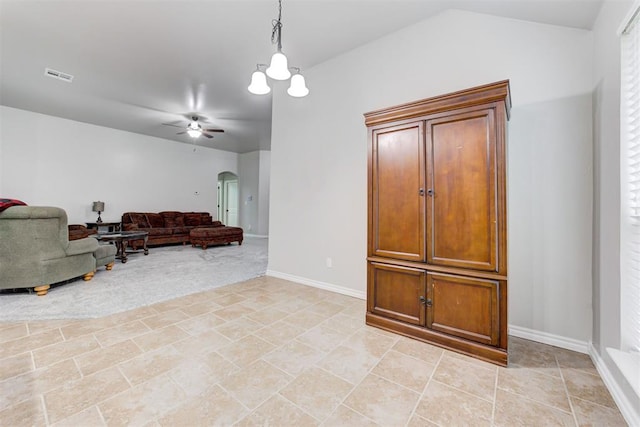 tiled living room featuring ceiling fan and lofted ceiling