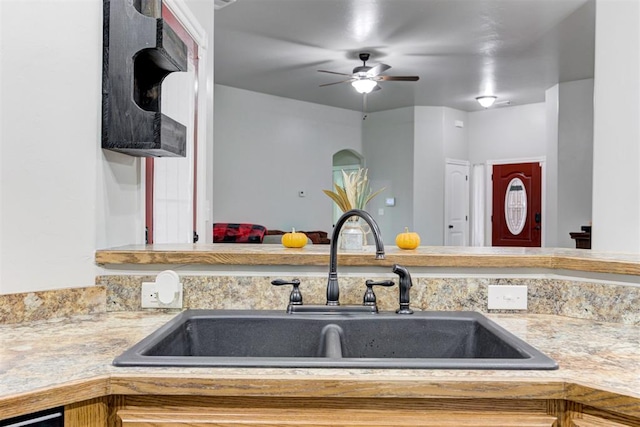 kitchen featuring ceiling fan and sink