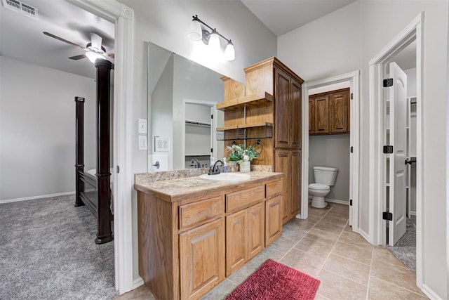 bathroom with tile patterned floors, ceiling fan, toilet, and vanity